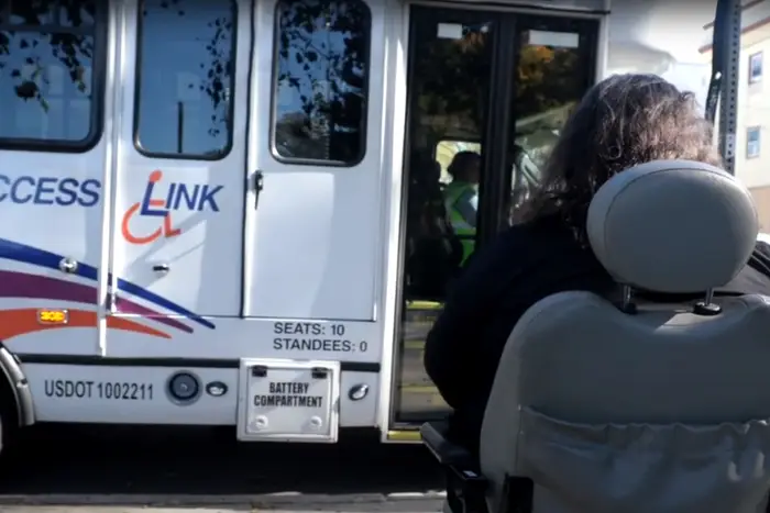 An Access Link van approaches a rider in a promotional video from its parent agency, NJ Transit. Riders say the service is frequently late or takes an excessively long time to complete trips.
